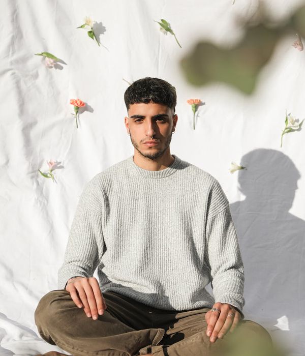 Person meditating peacefully with a calm background.